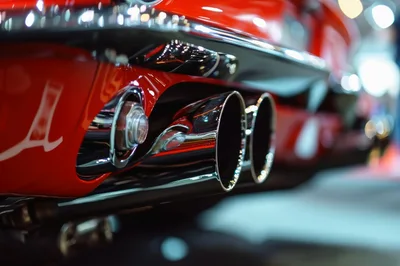 Close Up Of Chrome Exhaust Pipes On Red Sports Car