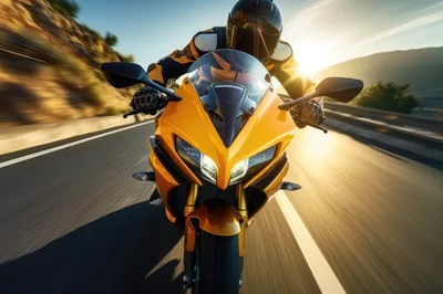 Motorcyclist Riding A Yellow Sportbike On A Coastal Road