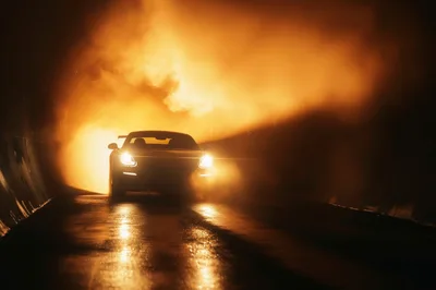 Sports Car Driving Through A Smoky Tunnel