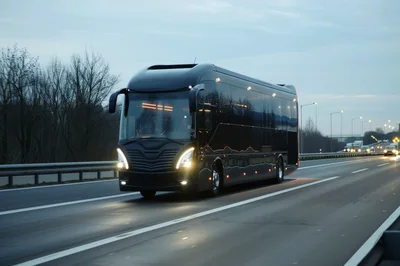 Modern Black Luxury Coach Bus Driving On Highway