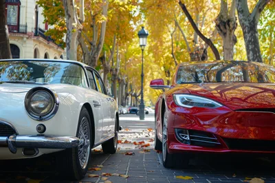 Classic White Sports Car And Modern Red Electric Vehicle