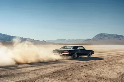 Black Muscle Car Drifting On Desert Dry Lake Bed