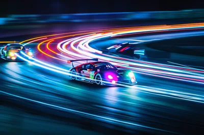 Racing Cars Speeding on Track at Night