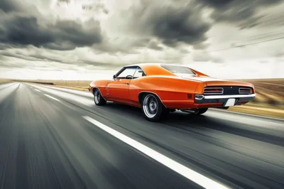 Orange Muscle Car Driving Fast On Highway