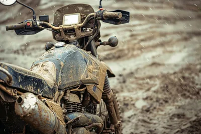 Muddy Dual Sport Motorcycle Parked In Rainy Terrain