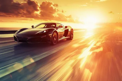 Black Supercar Driving Fast Along Coastal Highway At Sunset