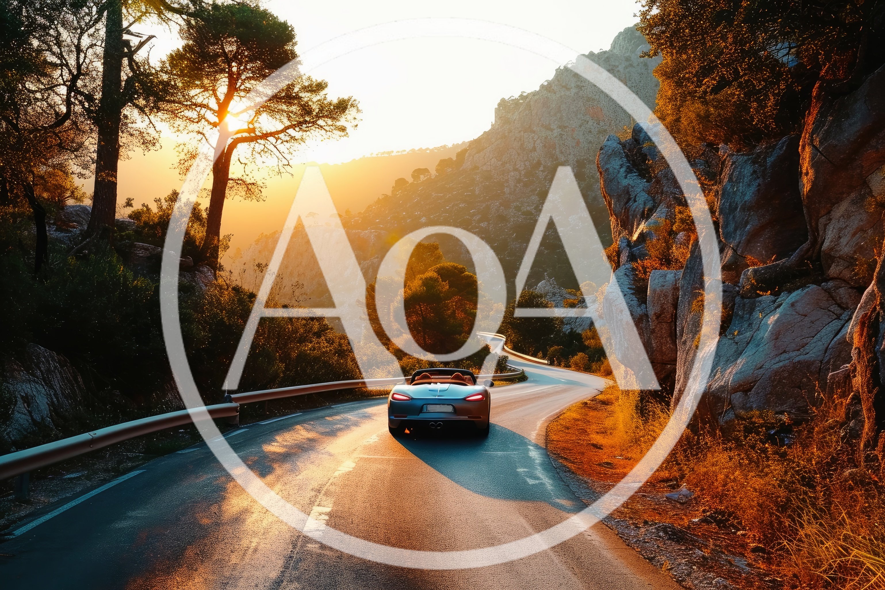 Silver Convertible Driving Along A Winding Mountain Road
