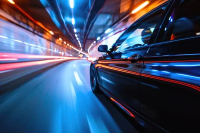 Black Car Driving Through A Motion Blurred Tunnel