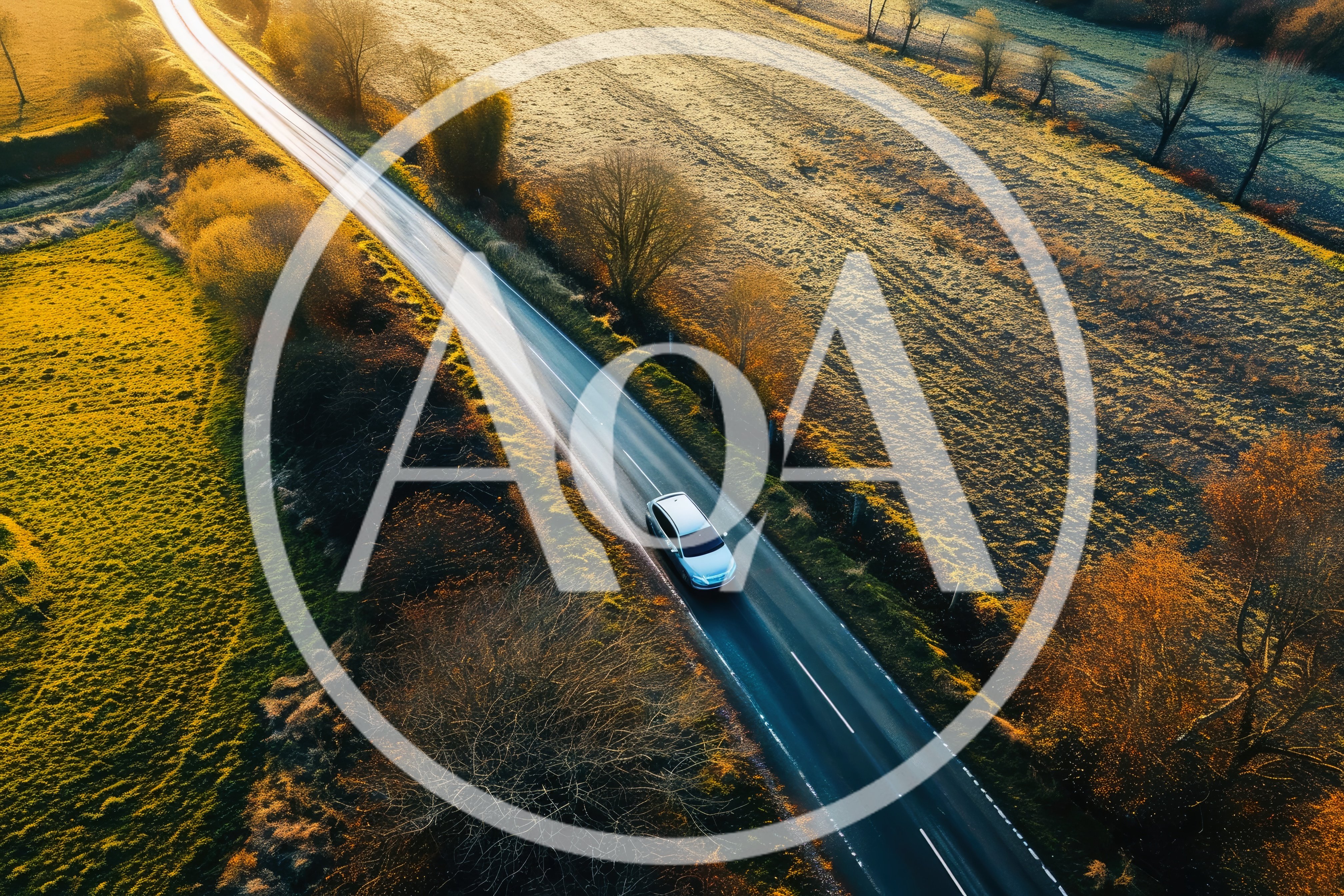 Aerial View Of A Silver Car Driving On Country Road