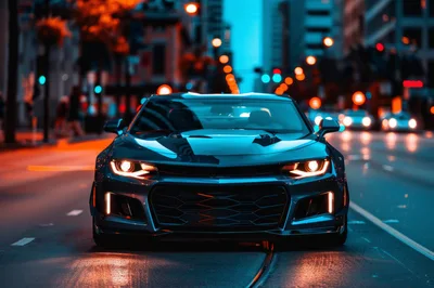 Modern Sports Car Driving Through City Streets At Night