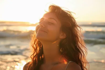 Young Woman Enjoying Sunset At The Beach