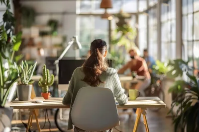 Woman Working At Desk In Bright Modern Office