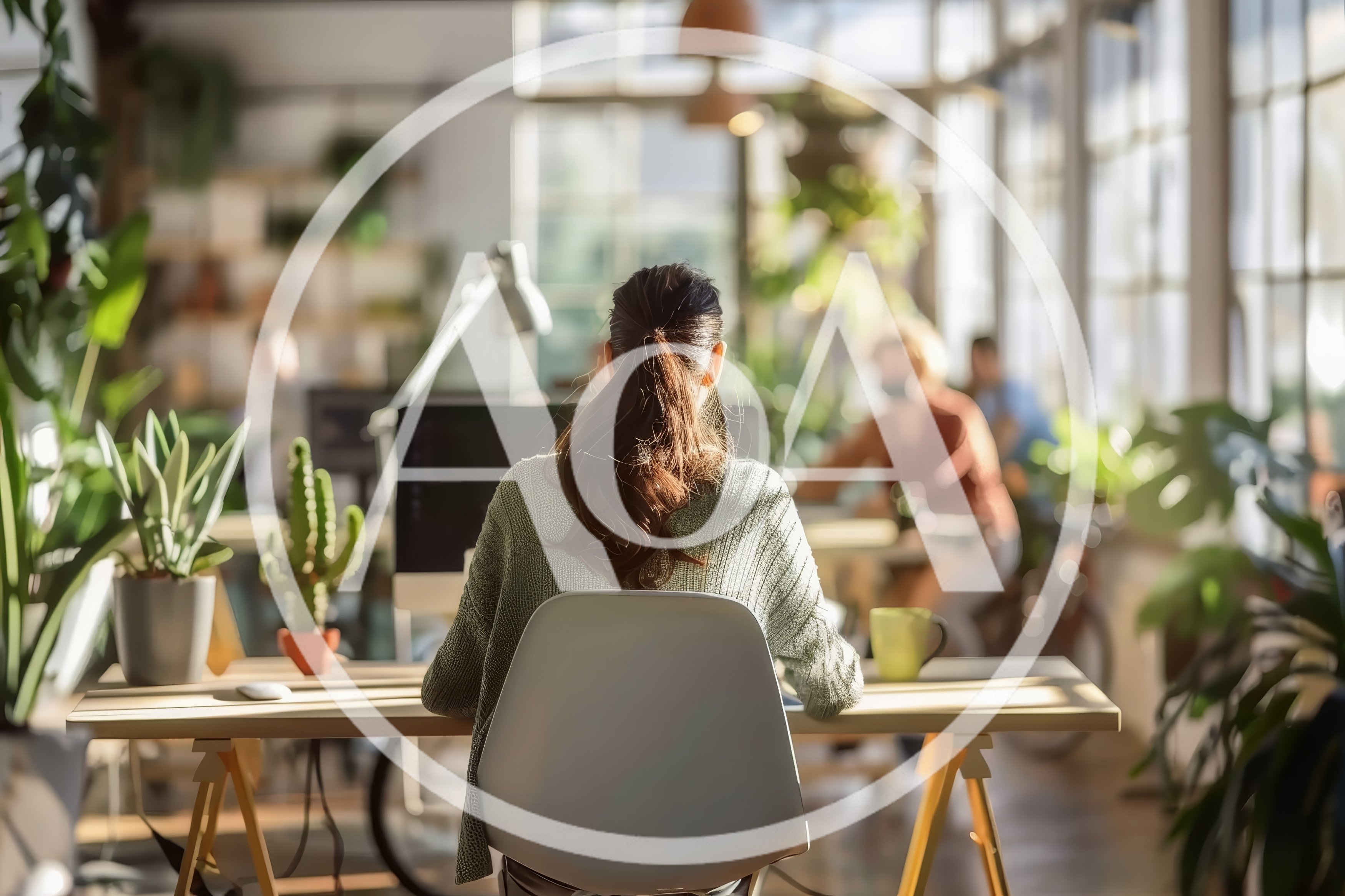 Woman Working At Desk In Bright Modern Office