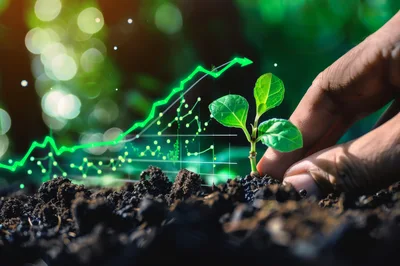 Hand Planting A Small Green Sprout With Financial Growth Chart