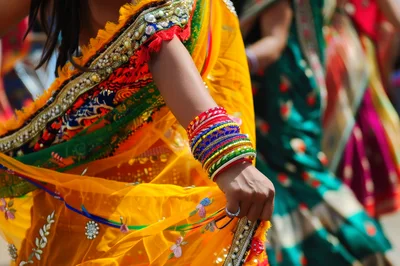 Indian Woman Dancing In Traditional Yellow Saree