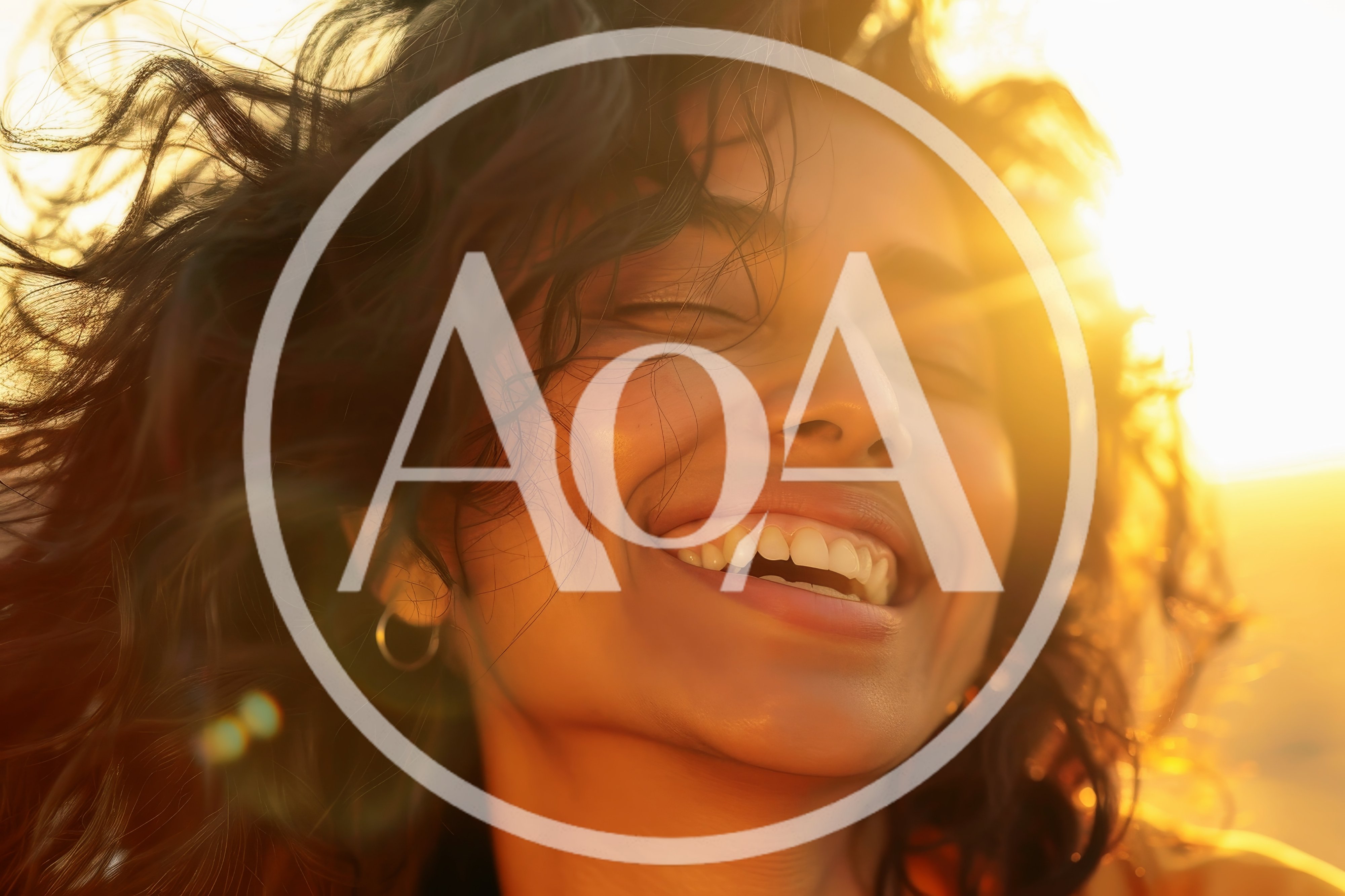 Happy Woman With Curly Hair Smiling In Golden Sunlight