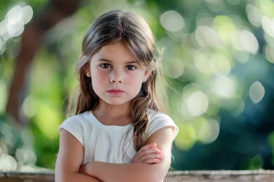 Portrait Of A Serious Young Girl With Crossed Arms