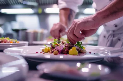 Professional Chef Plating Gourmet Dish In Restaurant Kitchen