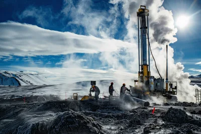 Geothermal Drilling Operations In A Snowy Volcanic Landscape