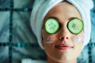 Woman Relaxing With Cucumber Slices On Eyes