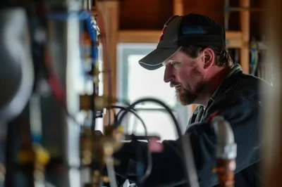 Professional Plumber Installing Residential Heating System