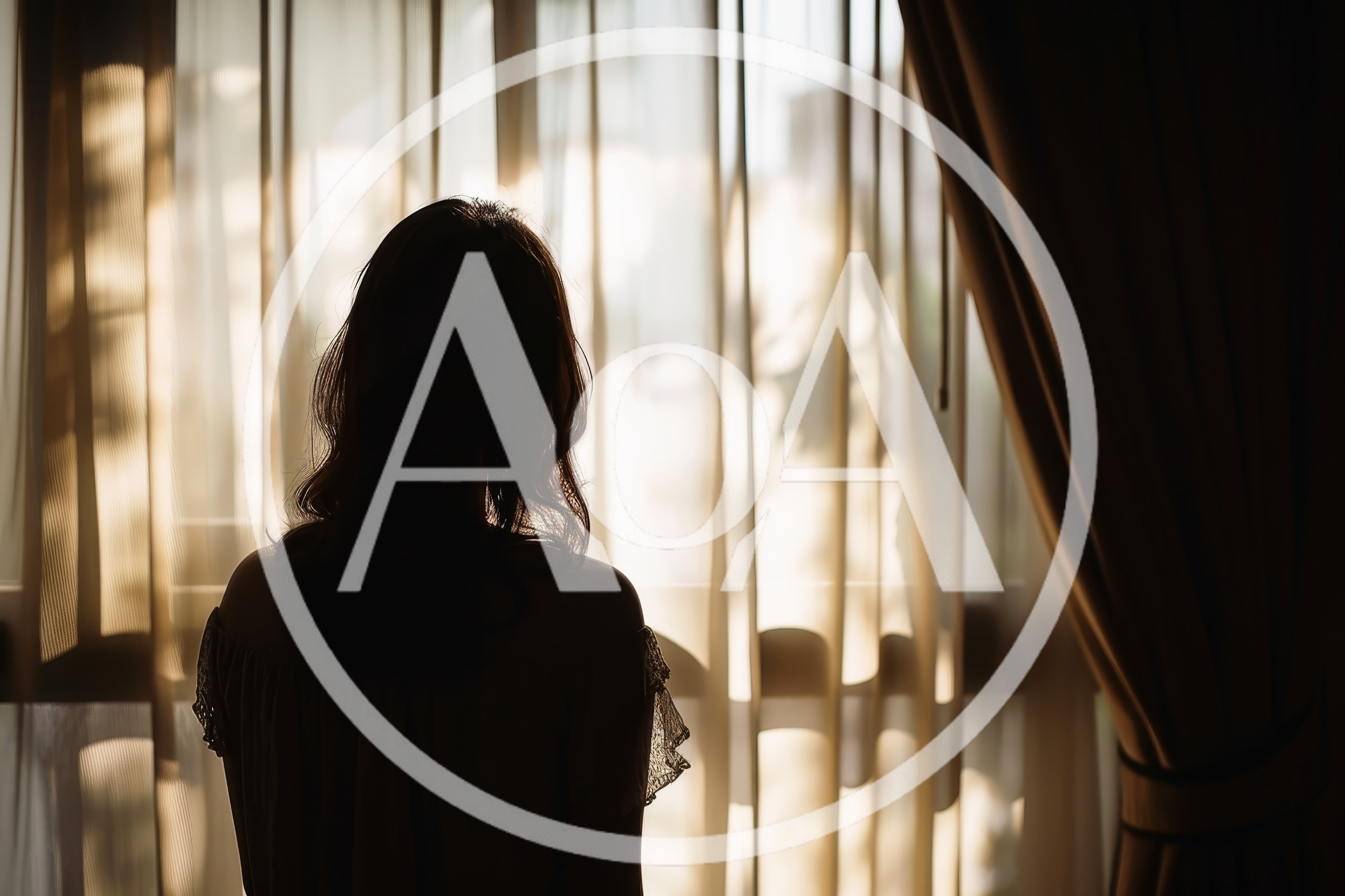 Silhouette Of A Woman Standing By A Window