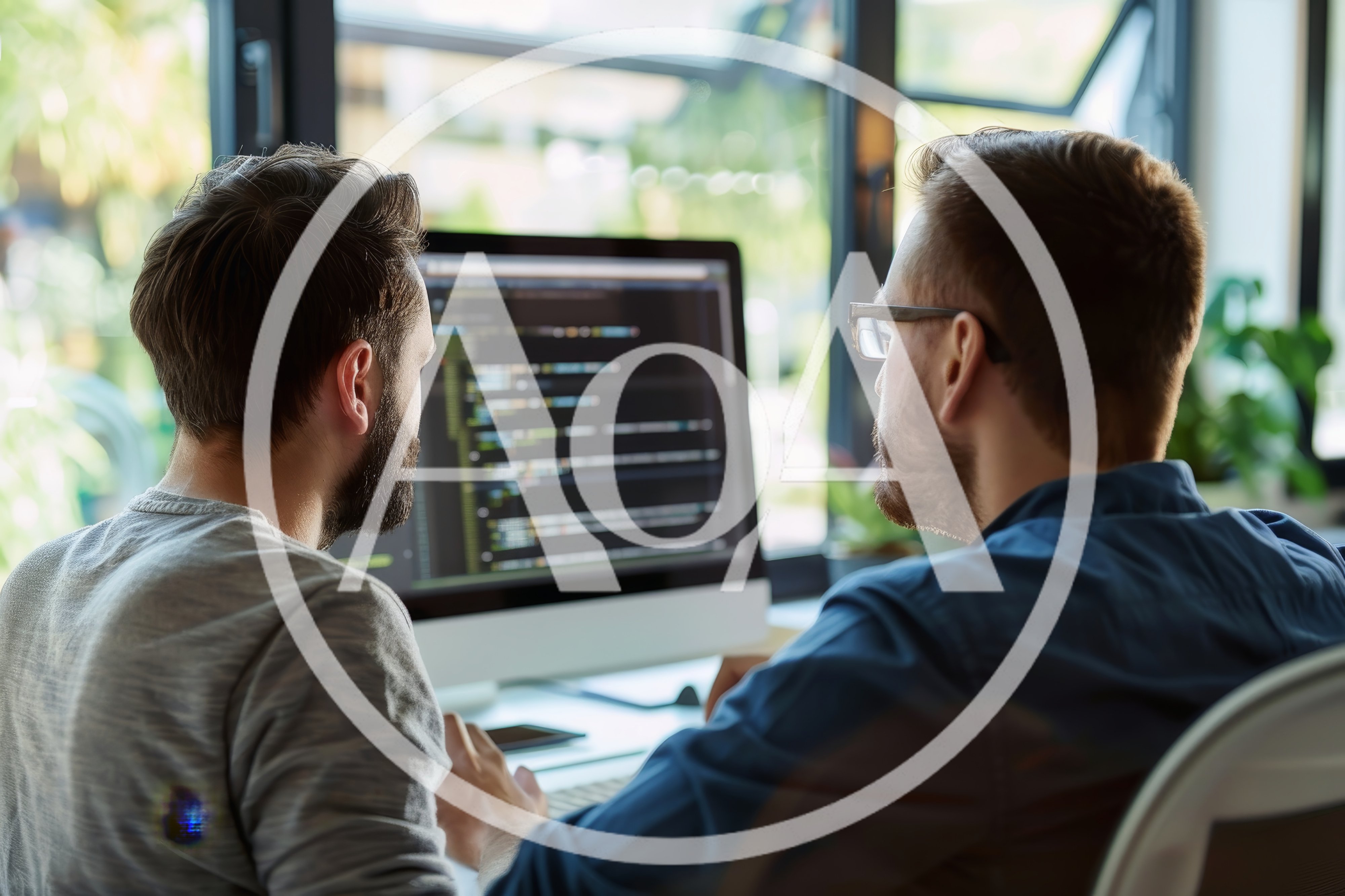 Two Software Developers Collaborating On Code At Office