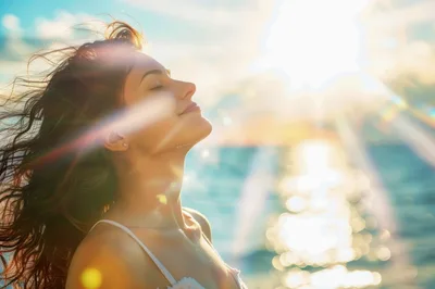 Young Woman Enjoying Sunset Breeze By The Ocean