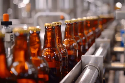 Brown Beer Bottles Moving Along Industrial Conveyor Belt
