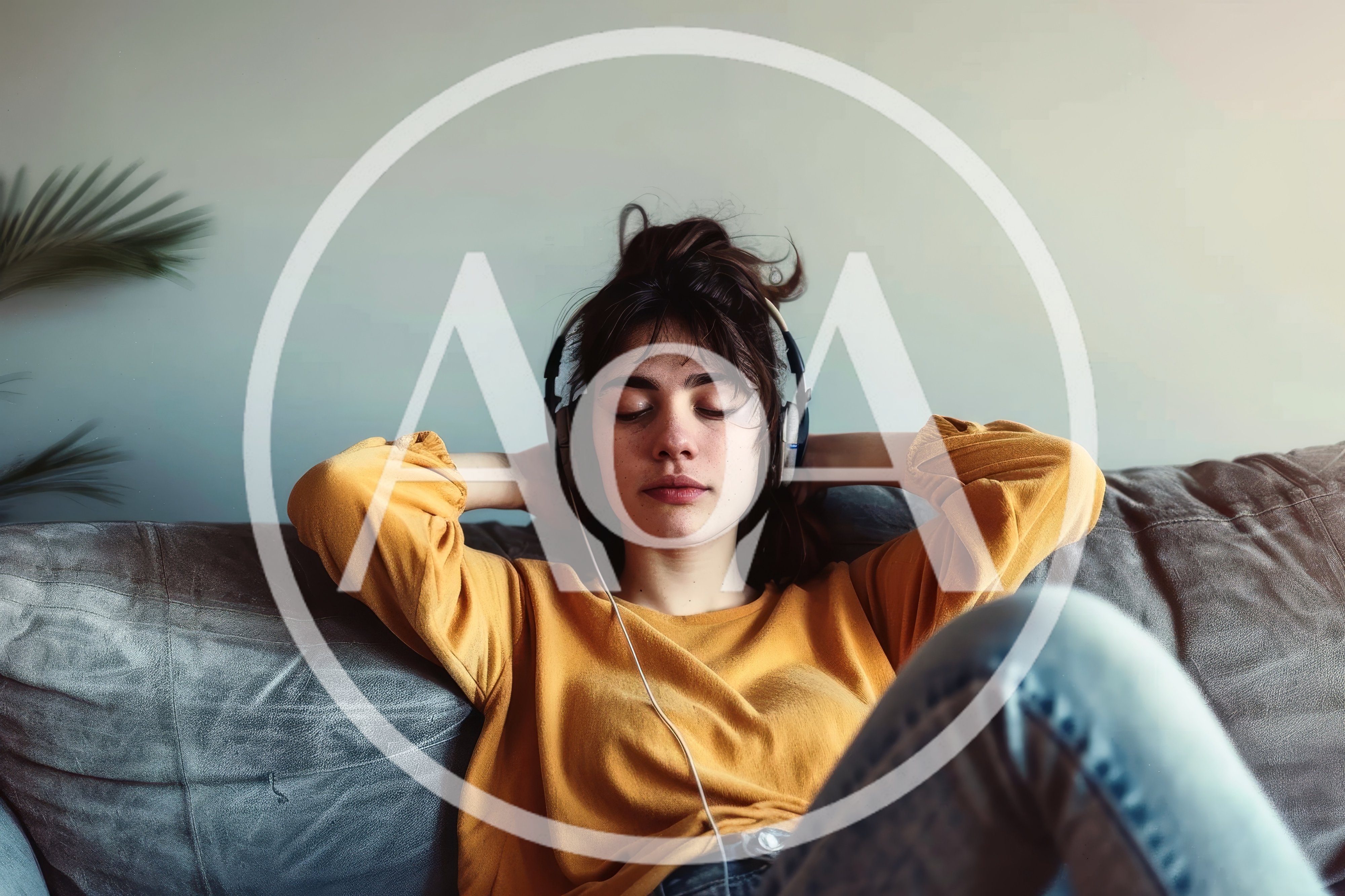 Young Woman Relaxing On Sofa Listening To Music