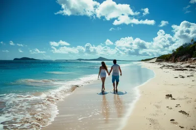 Couple Walking Hand In Hand Along A Tropical Beach