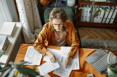 Young Person Working With Documents At Desk