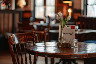 Reserved Table With Flowers In A Cozy Pub