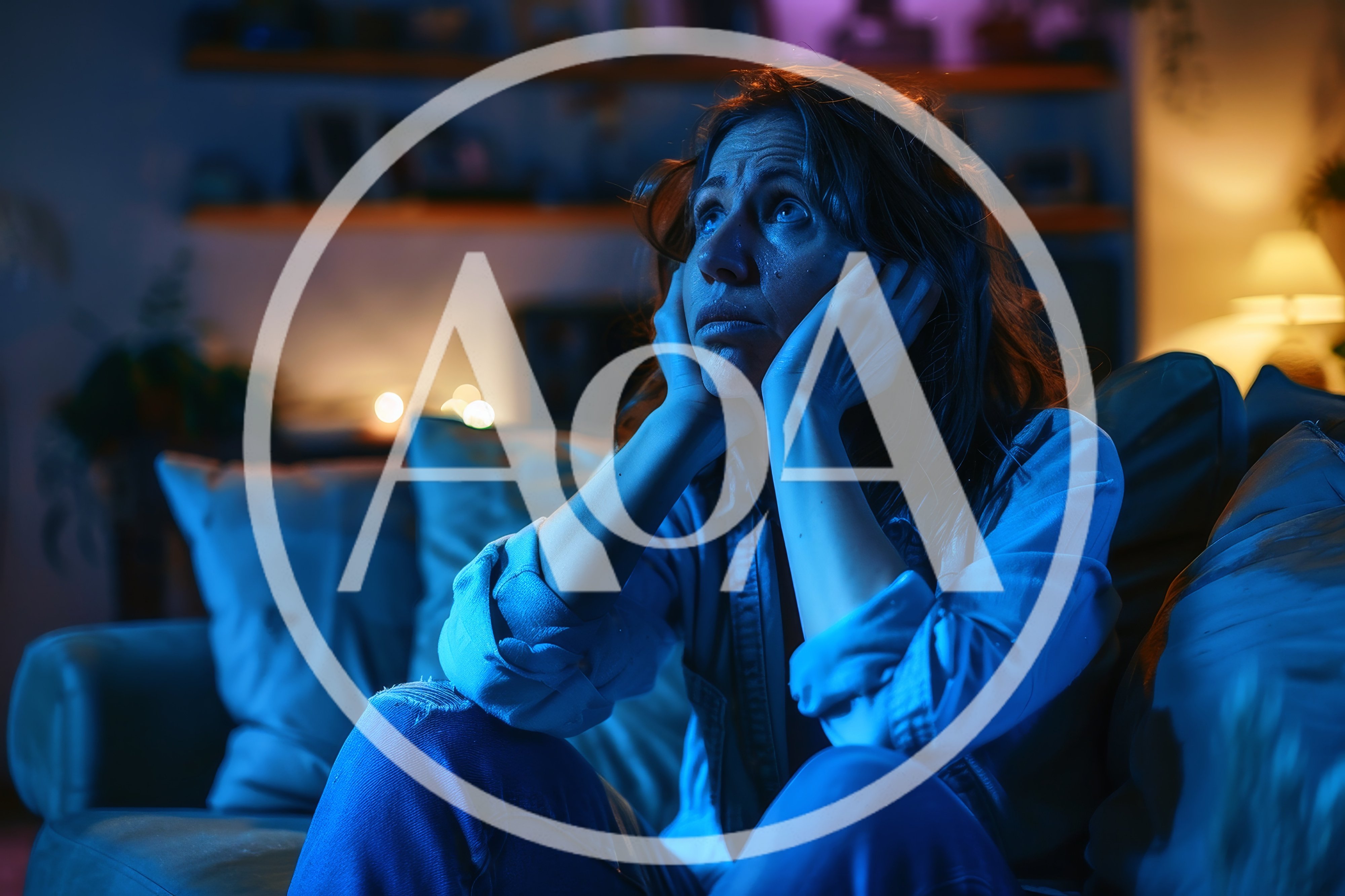 Sad Woman Sitting Alone on Couch at Night