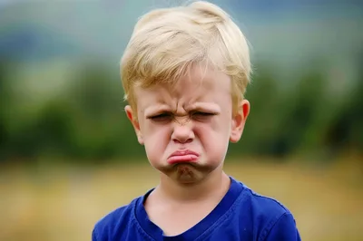 Young Boy Making A Grumpy Pouting Face