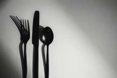 Black Cutlery Set With Dramatic Shadows