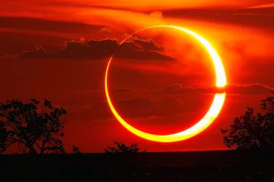 Annular Solar Eclipse Over A Silhouetted Landscape