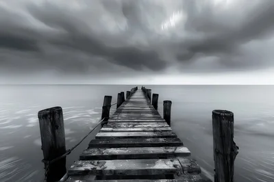 Long Wooden Pier Extending Into Calm Still Water