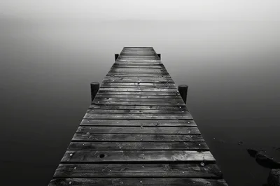 Wooden Pier Extending Into Foggy Lake