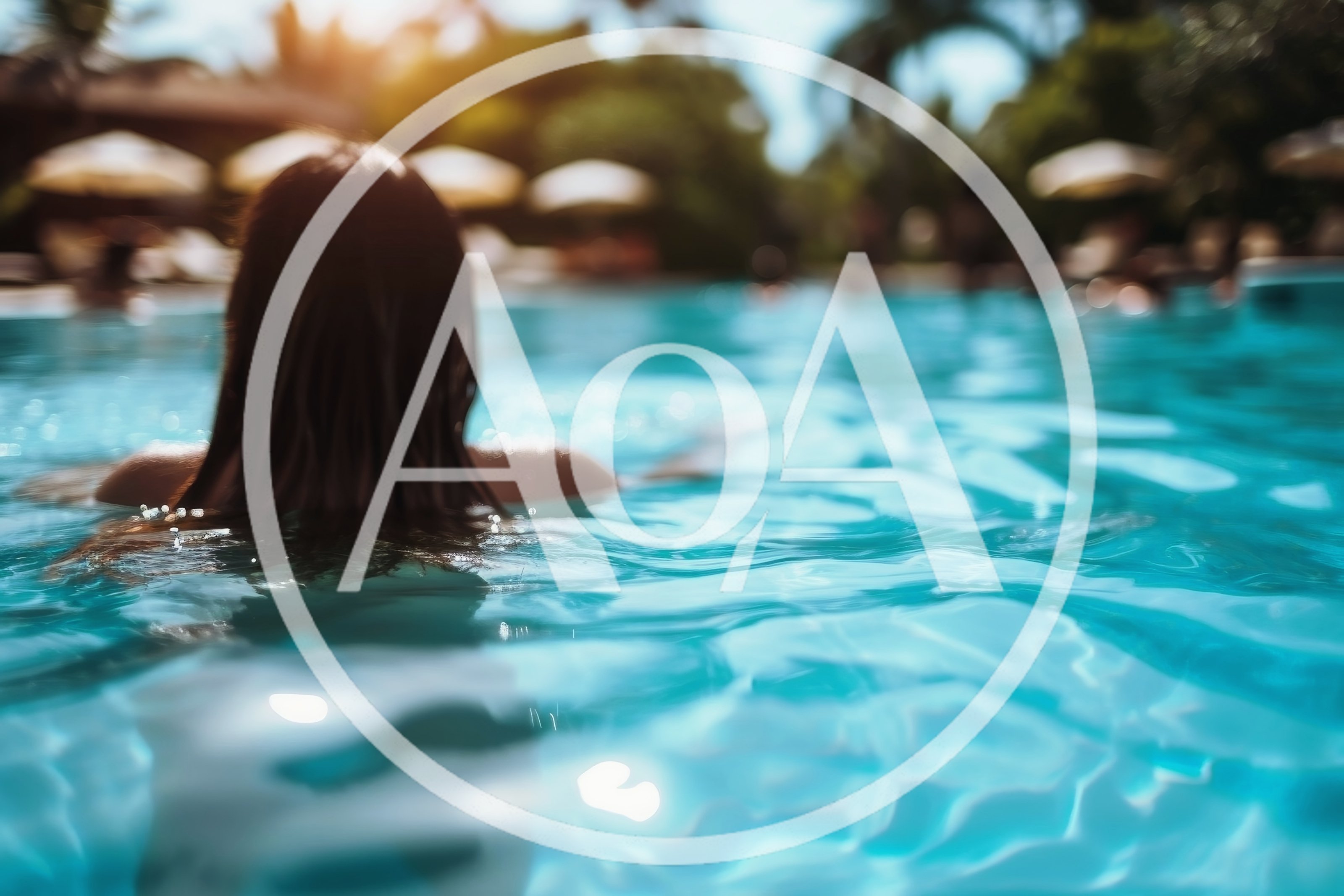 Woman Swimming In A Tropical Resort Pool