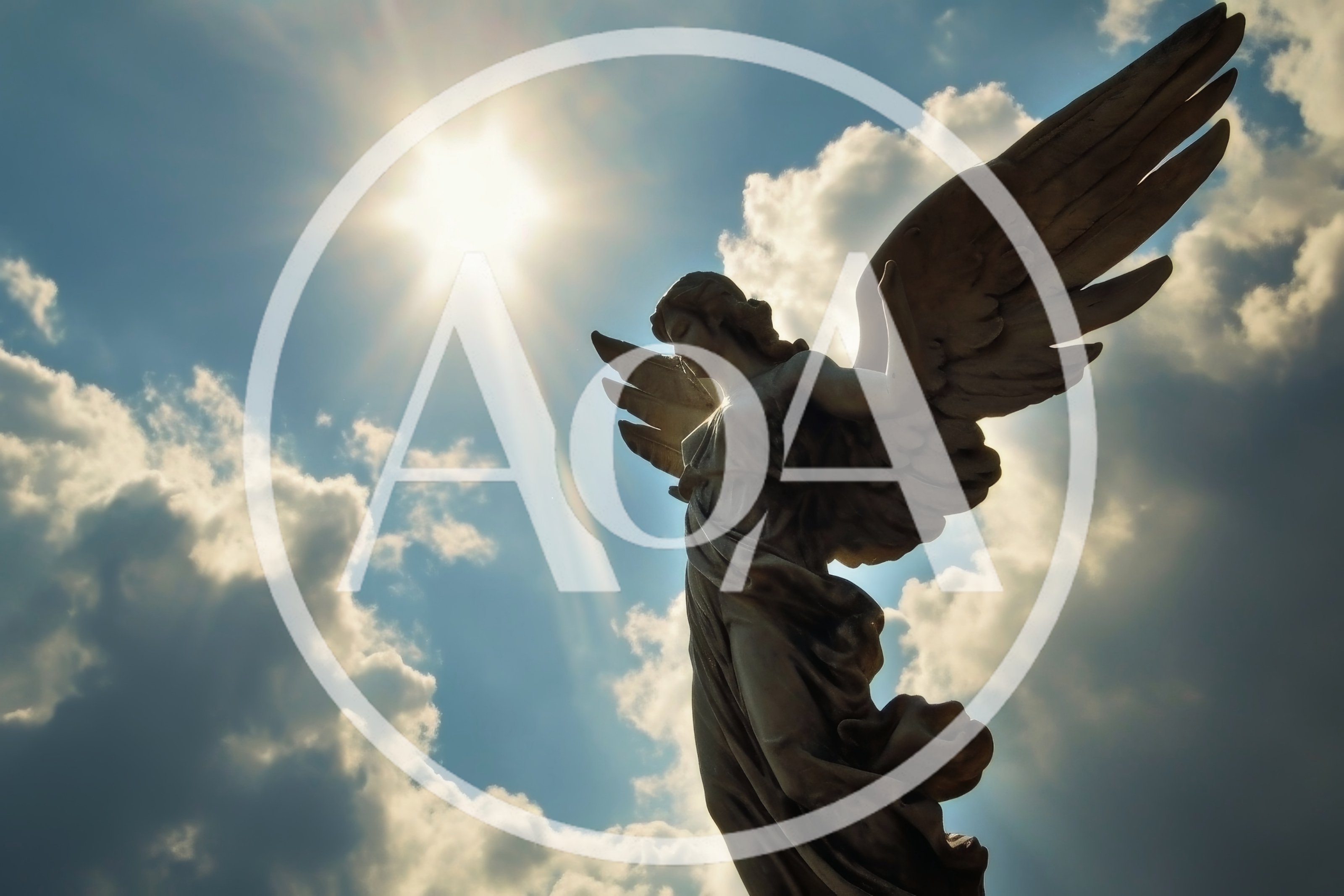 Stone Angel Statue Against Sunlit Cloudy Sky