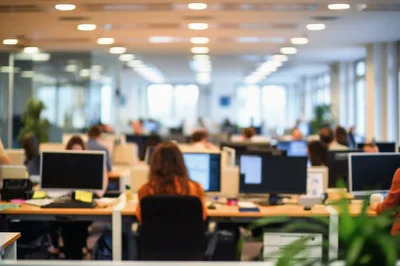 Busy Open Plan Office With Employees Working At Desks
