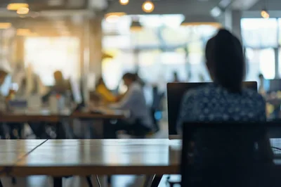 Professional Woman Working At Desk In Modern Office