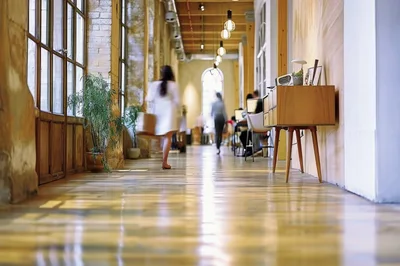 People Walking Through A Bright Modern Office Hallway