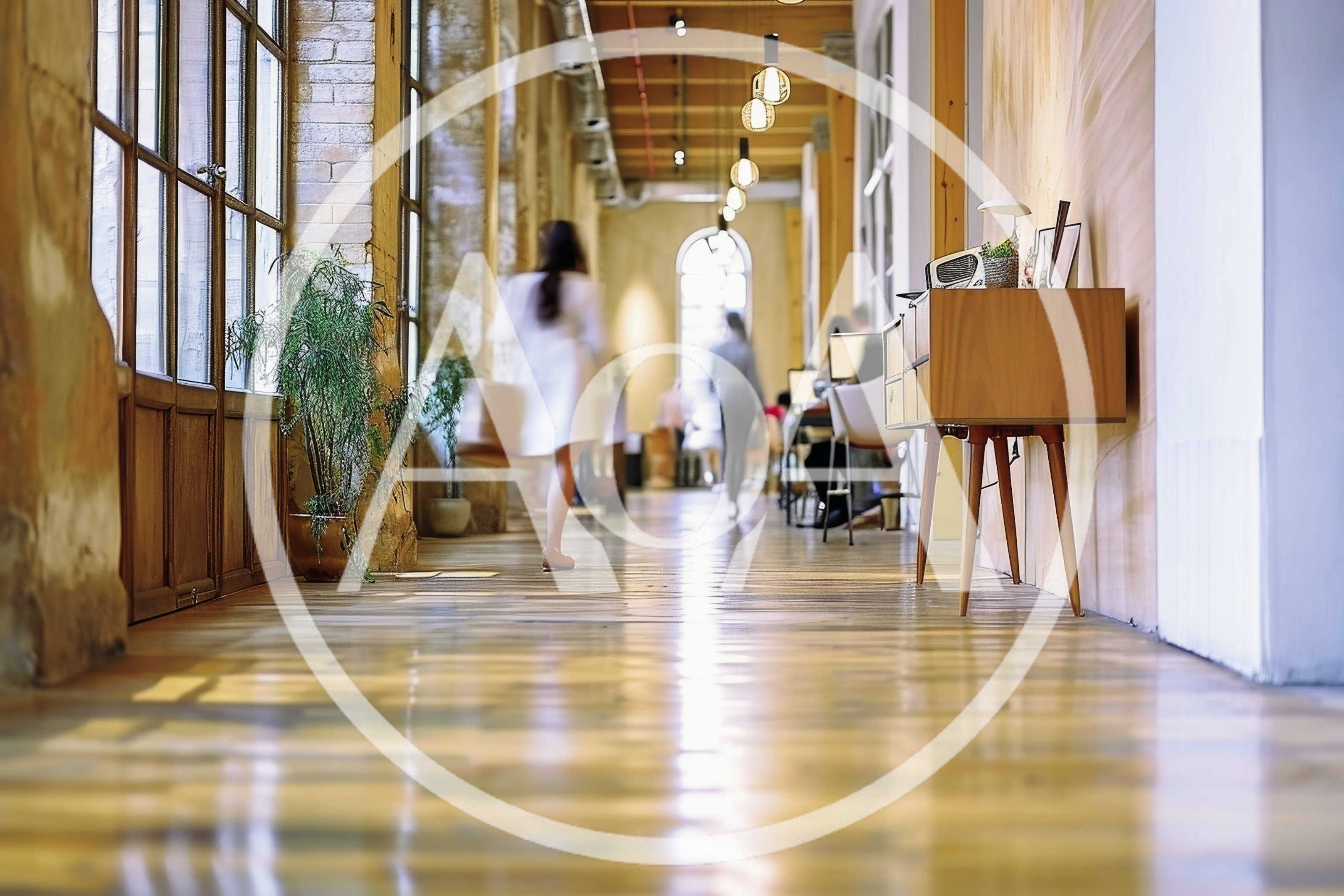 People Walking Through A Bright Modern Office Hallway