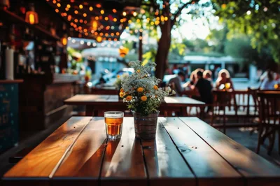 Beer Glass And Flower Pot On Outdoor Restaurant Table