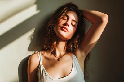 Young Woman Posing With Sunlight And Shadow Patterns