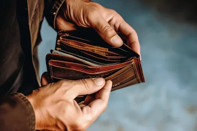 Person Holding An Open Leather Wallet