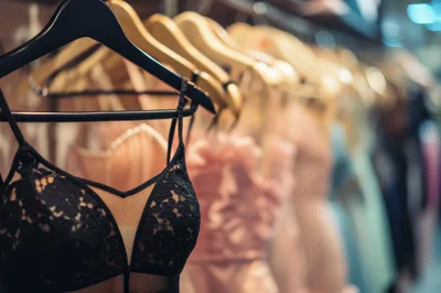 Black Lace Lingerie Bodysuit Hanging On A Clothing Rack