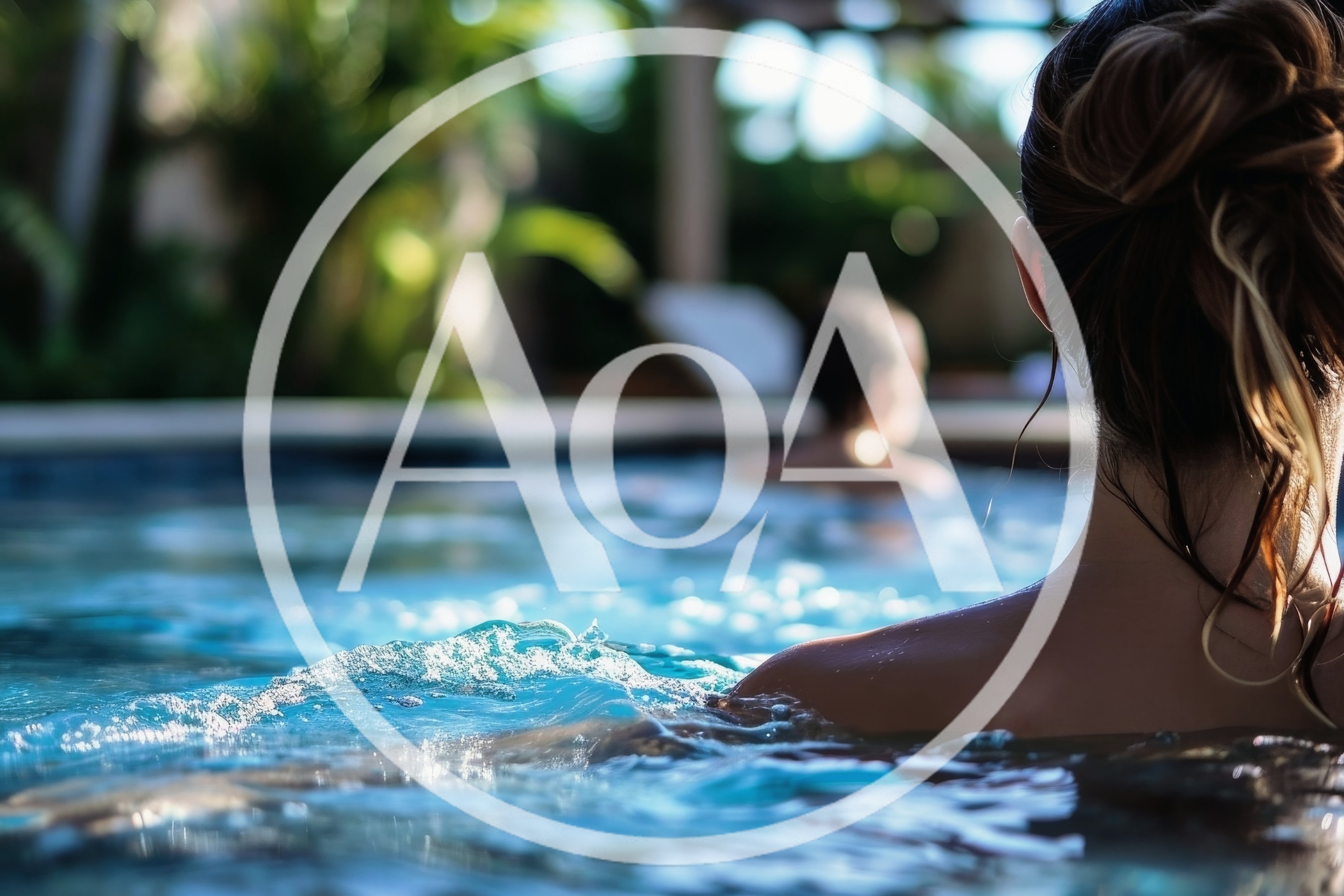 Woman Relaxing In A Luxury Resort Swimming Pool